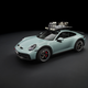 A grey-green 2023 Porsche 911 Dakar with roof rack parked in front of a black background.